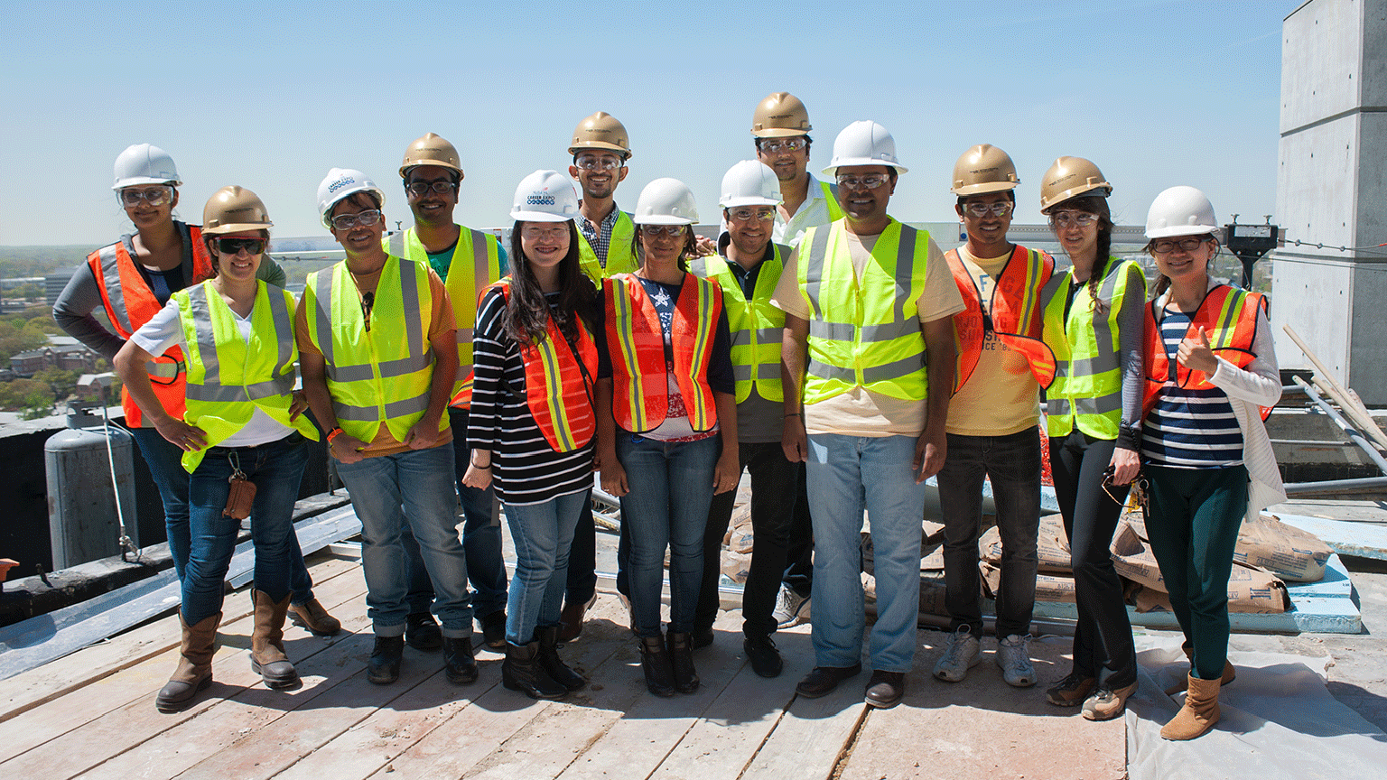 Group of students with PPE construction on top of a building