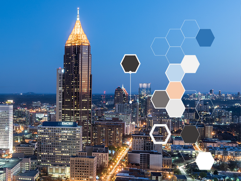 A hive diagram in front of the Atlanta skyline at night.