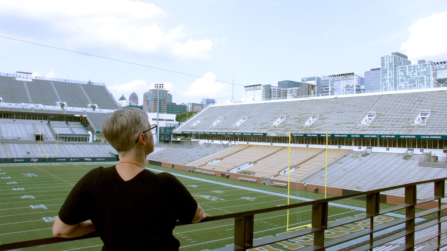 Michelle Rinehart looks out on the Bobby Dodd Stadium field and Atlanta skyline.