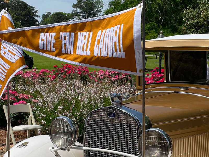 A flag on the Ramblin Wreck that says "Give 'Em Hell Caddell"