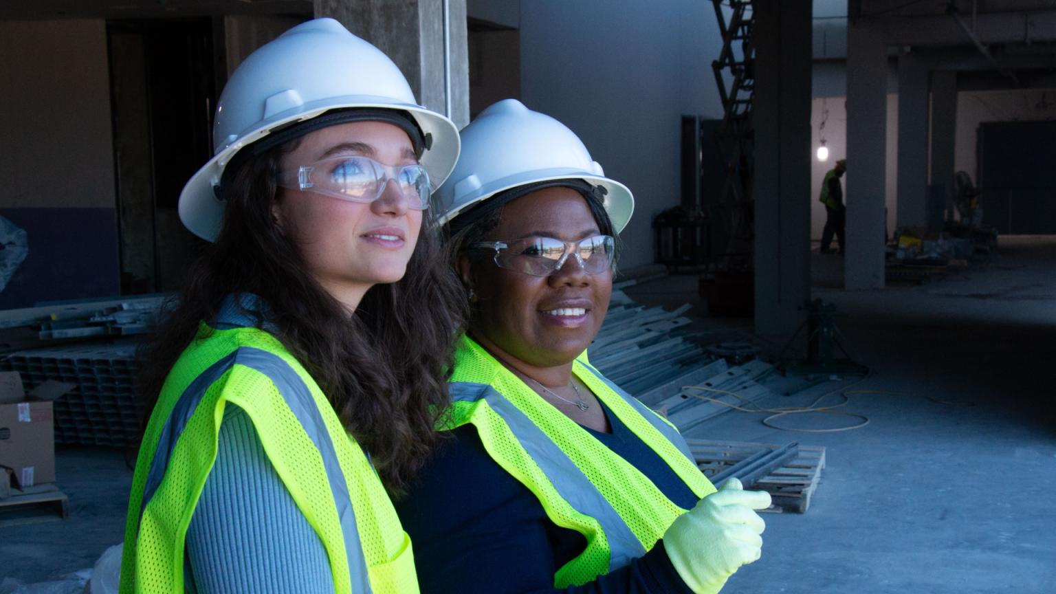 A student and her professor in PPE on a construction worksite.