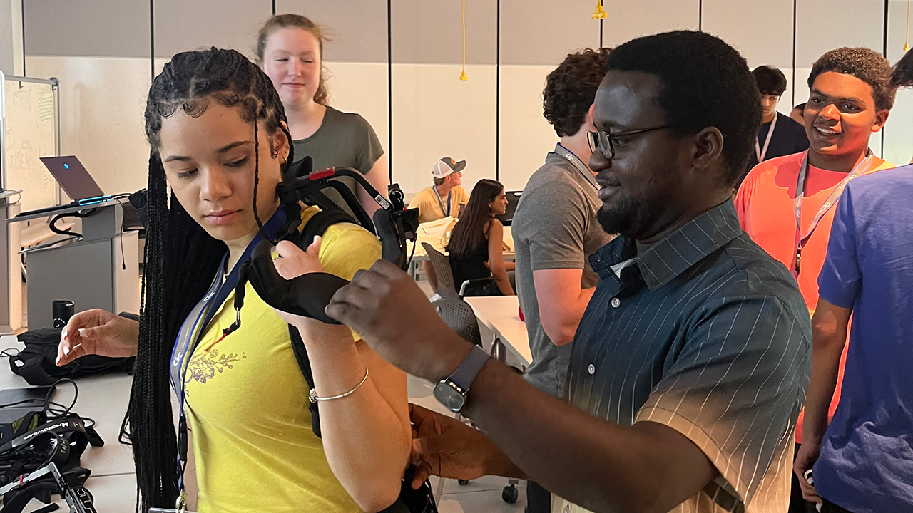 Student trying on an exoskeleton