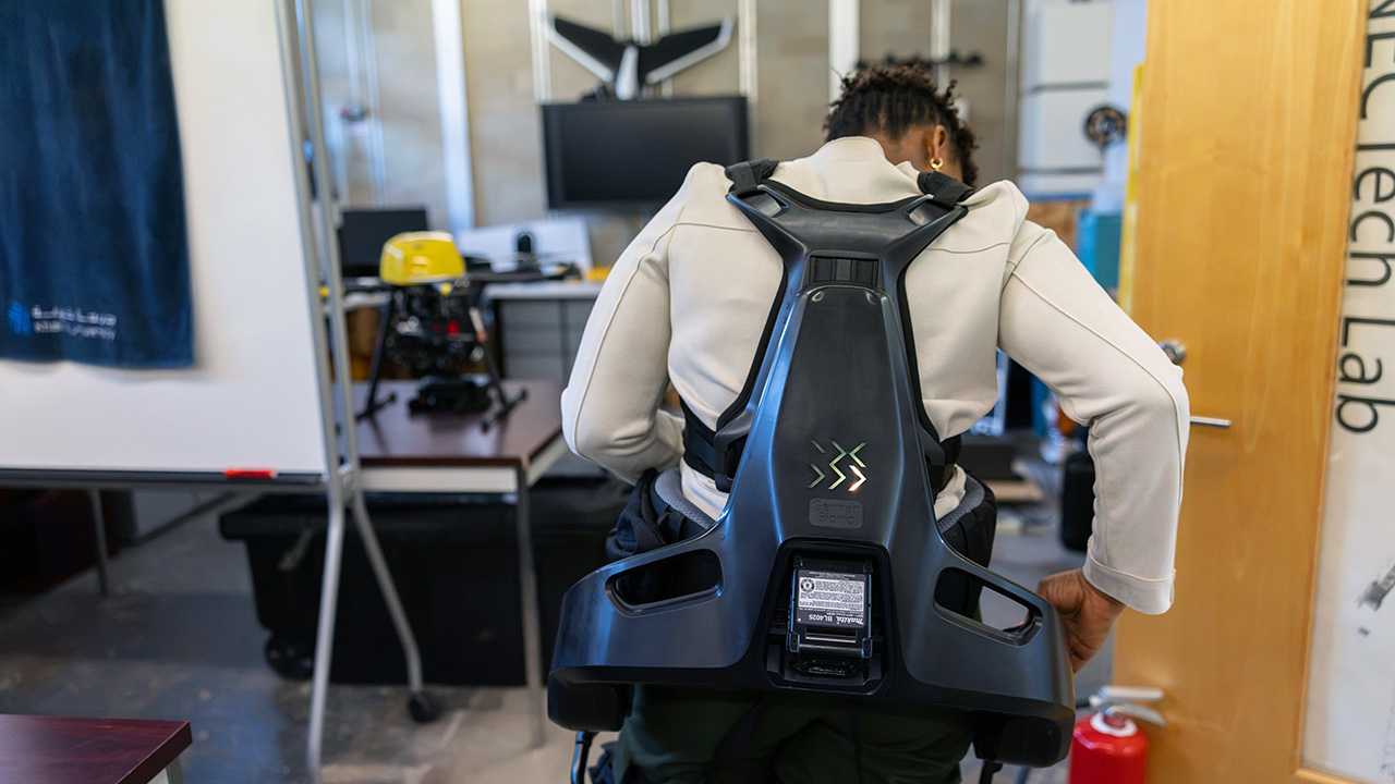Person wearing a powered exoskeleton in a lab setting
