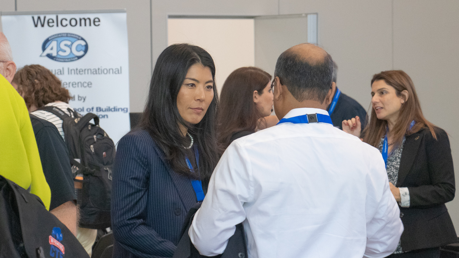 Assistant Professor Eunhwa Yang talks with a conference attendee during lunch.