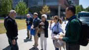 Conference attendees outside on sunny day.